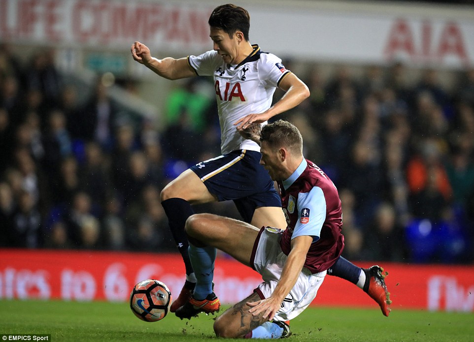 South Korea international Son Heung-min jumps to evade a challenge from Aston Villa defender Nathan Baker