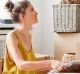 Young man and woman unpacking cardboard boxes at new apartment