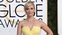 Reese Witherspoon arrives at the 74th annual Golden Globe Awards wearing a strapless yellow gown