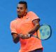Pushing through it: Nick Kyrgios insists a knee complaint won't stop his Australian Open campaign.