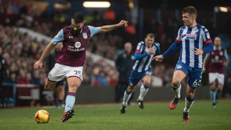 Max Power of Wigan Athletic (right) marks Australia's, and Aston Villa's, Mile Jedinak in a recent match.