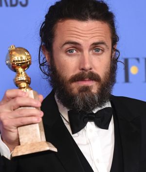 Casey Affleck poses in the press room with the Golden Globe award for his performance in 'Manchester by the Sea'. 