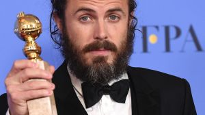 Casey Affleck poses in the press room with the Golden Globe award for his performance in 'Manchester by the Sea'. 