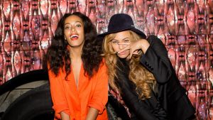 Solange Knowles (L) and Beyonce Knowles pose for a photo against the bounce bus at the cocktail reception for "Amen ...