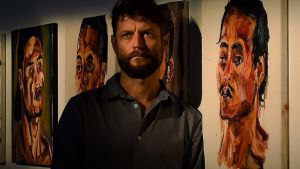 Artist Ben Quilty with some of Myuran Sukumaran's paintings that are a part of 'Another Day In Paradise' an exhibition ...