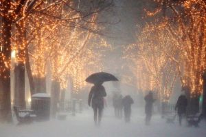 People walk through the Commonwealth Avenue Mall during a winter storm in Boston, A storm that wreaked havoc along the ...