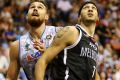 Josh Boone of Melbourne United (right) tangles with Adelaide's Eric Jacobsen.