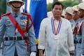 Philippine President Rodrigo Duterte reviews the troops as he leads a flag-raising ceremony in December.