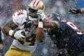Chicago's Akiem Hicks (right) tackles the 49ers' Shaun Draughn in the snow, and this weekend, it's going to freeze.
