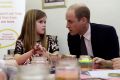 Prince William, Duke of Cambridge speaks to Aoife, 9, during his visit to a Child Bereavement UK Centre in Stratford on ...