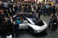 People gather around the Faraday Future's FF 91 electric car at CES 2017, in Las Vegas.