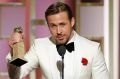 Ryan Gosling with the award for best actor in a motion picture musical or comedy for <i>La La Land</i>.