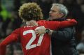 Feeling good: Manchester United manager Jose Mourinho and Marouane Fellaini enjoy the moment.