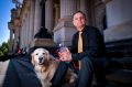 Greg Kasarik and his golden retriever Saasha. Mr Kasarik uses LSD every couple of months to achieve "mystical transcendence".