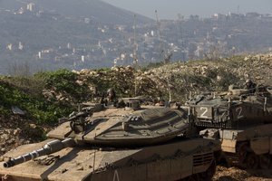 Israeli soldiers sit in tanks near the in Israel-Lebanon Border, northern Israel, Tuesday, Jan. 20, 2015.