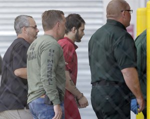 Esteban Santiago, third from left, accused of fatally shooting several people and wounding multiple others at a crowded Florida airport baggage claim, is returned to Broward County's main jail after his first court appearance, Monday, Jan. 9, 2017, in Fort Lauderdale, Fla.