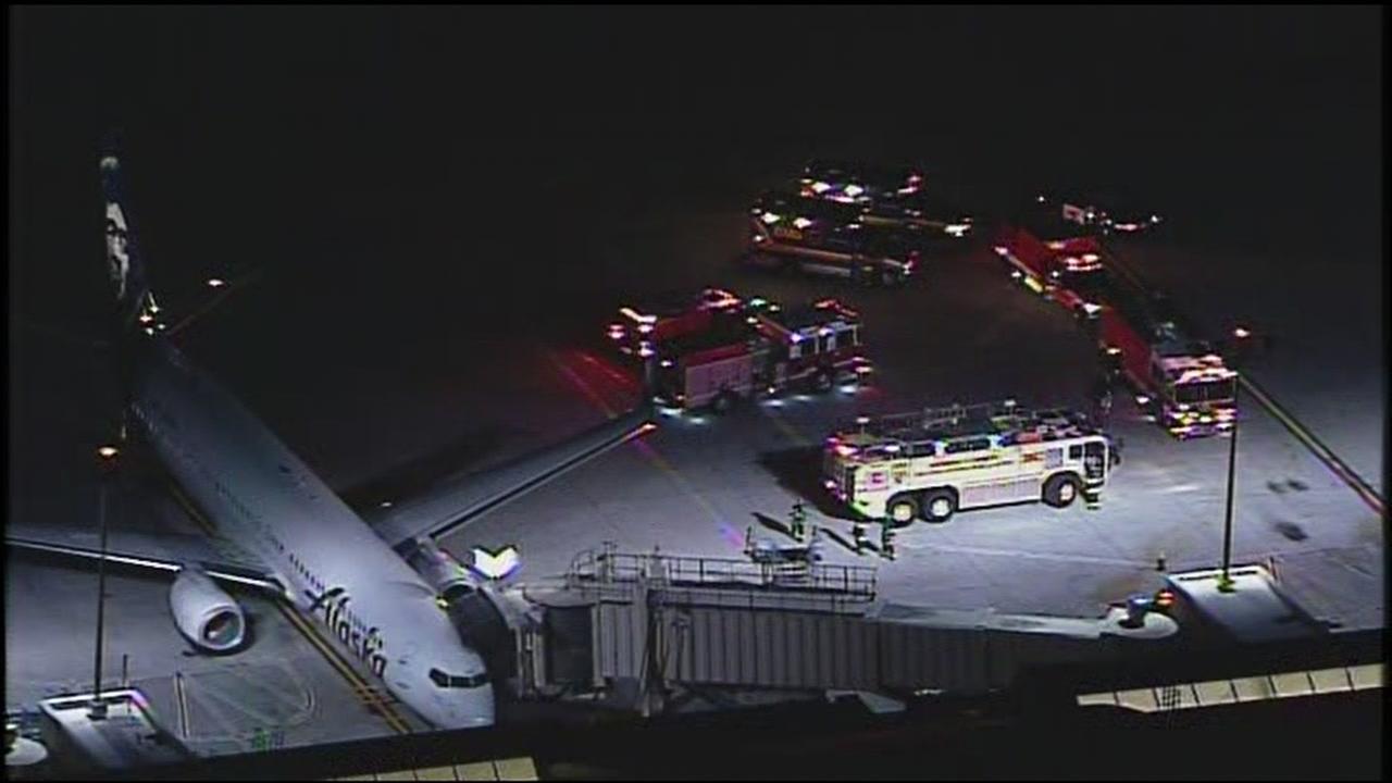 Hazmat, police and fire officials respond to a report of an unknown illness on an Alaskan Airlines flight in San Jose, Calif. on Jan. 12, 2017.