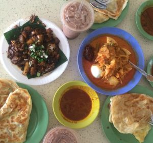 Dishes at Tiong Bahru Hawker Centre including lontong, prata, iced milo and black carrot cake.