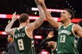 Milwaukee's Malcolm Brogdon and Michael Beasley celebrate their win.