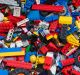 View from above into a box with many different colourful Lego bricks. Multiple generations of Legos (brick designs from ...