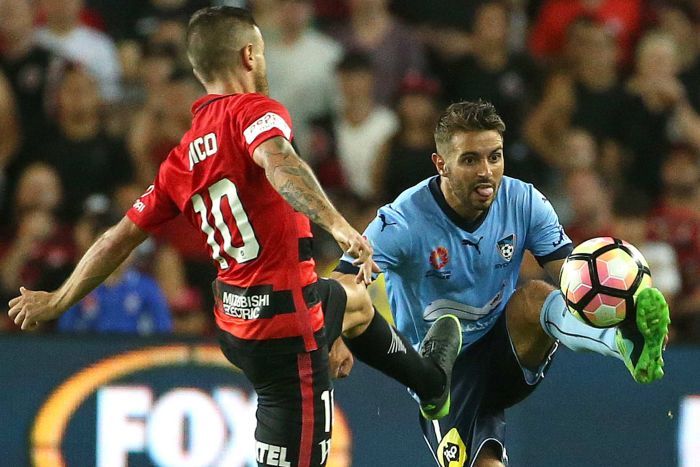 Michael Zullo of Sydney FC controls the ball as Nicolas Martinez of the Wanderers challenges.