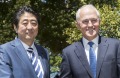 Japanese Prime Minister Shinzo Abe is greeted by the Australian Prime Minister Malcom Turnbull on arrival at Kirribilli ...