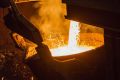 Molten copper flows from a furnace into a ladle at the Aurubis AG metals plant in Hamburg, Germany.