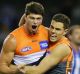 Pumped: Jonathon Patton (left) celebrates a goal against North Melbourne.