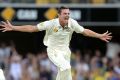 Howzat: Josh Hazlewood celebrates taking the wicket of Younis Khan at the Gabba on day two.