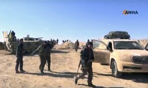 This frame grab from video provided on Monday, Nov. 7, 2016, by the Hawar News Agency, shows U.S.-backed fighters deployed during fighting with the Islamic State group in the village of Laqtah, north of Raqqa, Syria.