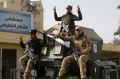 Iraqi security forces flash V signs for victory outside al-Salam hospital in Mosul, Iraq, in early January.