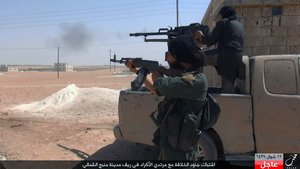 This undated image posted online on July. 18, 2016, by supporters of the Islamic State militant group on an anonymous photo sharing website, shows Islamic State fighters fire their weapons during clashes with the Kurdish-led Syria Democratic Forces in Manbij, in Aleppo province, Syria.