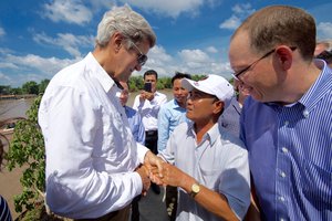 U.S. Secretary of State John Kerry shakes hands with 70-year-old Vo Ban Tam - who was part of a team that attacked the Secretary's Swift Boat on February 28, 1969, prompting the Secretary to kill his 24-year-old friend and fellow soldier, Ba Thanh.