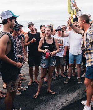 A group of men surround a young woman and shout 'black top, black top' requesting she remove her top. She didn't remove ...