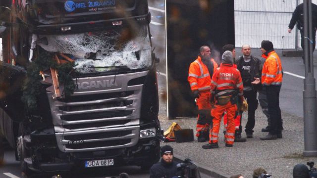 Security and rescue workers stand next to a truck which ploughed into a market in Berlin on December 20.