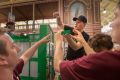 Brick by brick: Tim Burdon creates a phone booth at Brickvention, at the Royal Exhibition Building on Sunday.