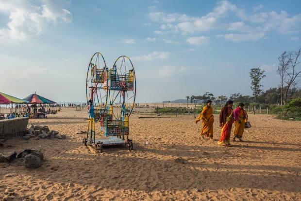 On a beach south of Chennai, India pilgrims gather to greet the rising sun.  There are numerous activities such as horse ...