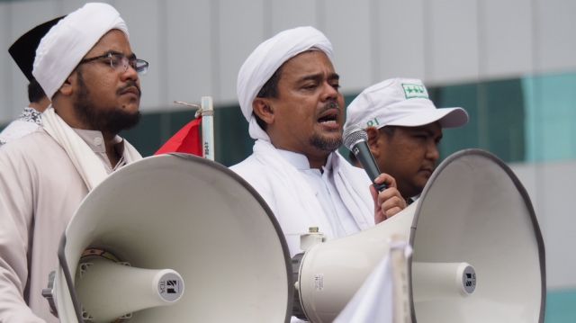 Muhammad Rizieq Shihab, also known as Habib Rizieq, addresses protesters outside Indonesian police headquarters.  