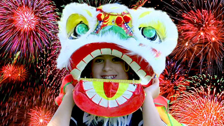 Child wearing dragon mask