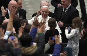 Pope Francis waves to faithful as he leaves after his weekly general audience in the Paul VI Hall at the Vatican, Wednesday, Jan. 11, 2017.