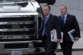 Donald Trump's chief of staff Reince Priebus, left, and incoming press secretary Sean Spicer, right, walk to their bus ...