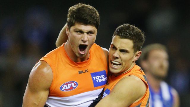 Pumped: Jonathon Patton (left) celebrates a goal against North Melbourne.