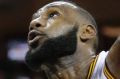 Cleveland Cavaliers' LeBron James, right, is called for an offensive foul against New Orleans Pelicans' Anthony Davis in ...