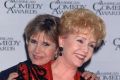 Actress Carrie Fisher hugging her mother, entertainer Debbie Reynolds, at the American Comedy Awards. 