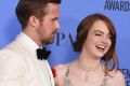 Ryan Gosling and Emma Stone with their Golden Globe awards for their performances in <i>La La Land</i>.