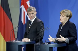 German Chancellor Angela Merkel, right, and the Prime Minister of New Zealand, Bill English, left, address the media during a joint news conference as part of a meeting at the chancellery in Berlin, Germany, Monday, Jan. 16, 2017.