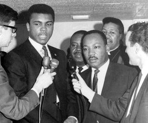 Heavyweight champion Muhammad Ali, center left, confers with Dr. Martin Luther King in this March 29, 1967 file photo.