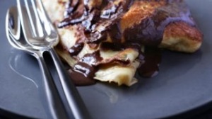 Walnut filled pancakes with chocolate sauce