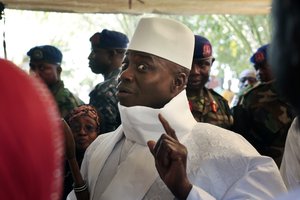 Gambia's president Yahya Jammeh shows his inked finger before voting in Banjul, Gambia, Thursday, Dec. 1, 2016.