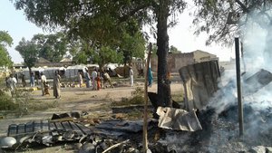 In this image supplied by MSF, smoke rises from a burnt out shelter at a camp for displaced people in Rann, Nigeria - Relief volunteers are believed to be among the more than 100 dead after a Nigerian Air Force jet fighter mistakenly bombed the refugee camp, while on a mission against Boko Haram extremists